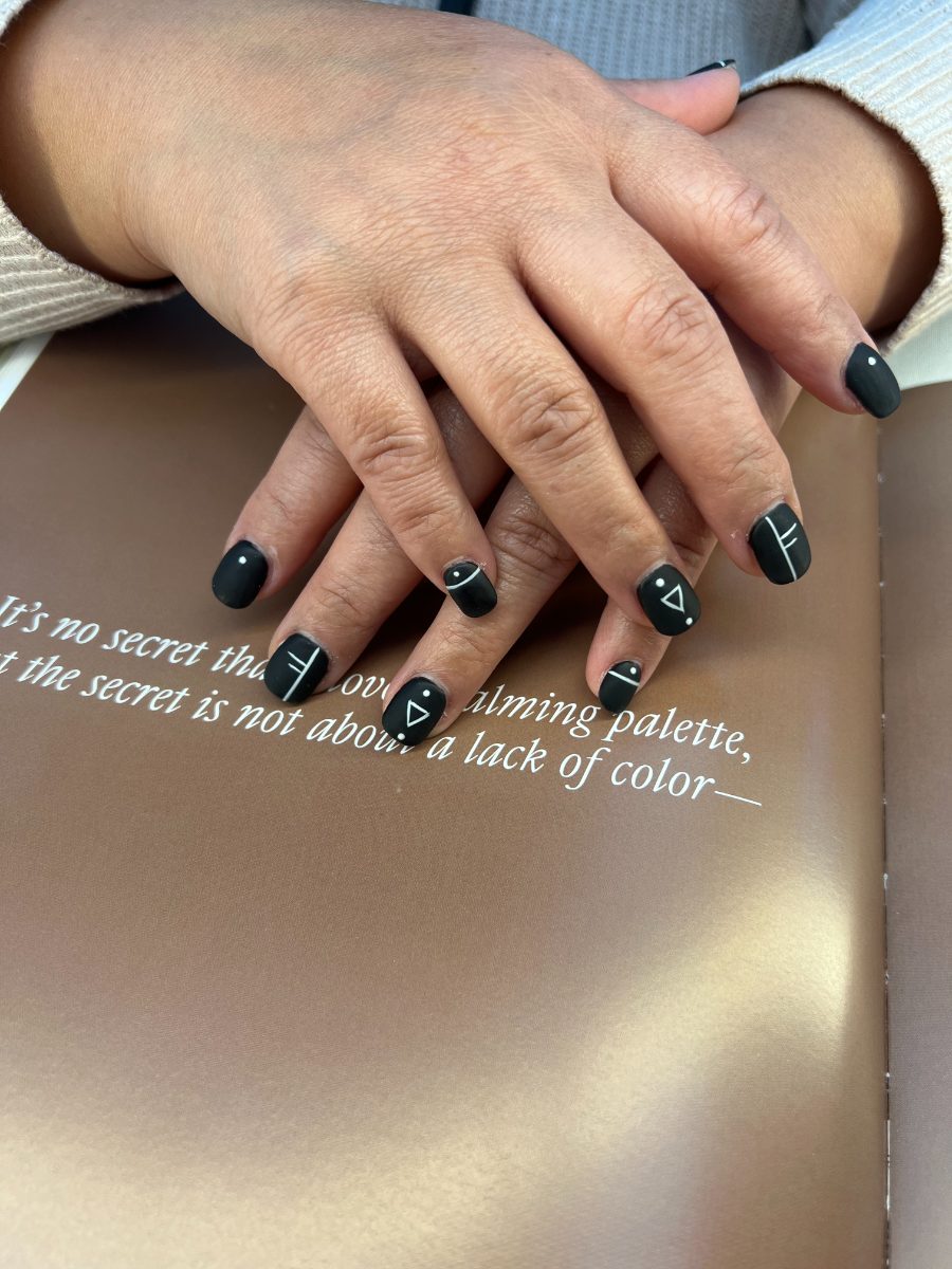 Matte black nails with white geometric line art at Tip N’ Toe